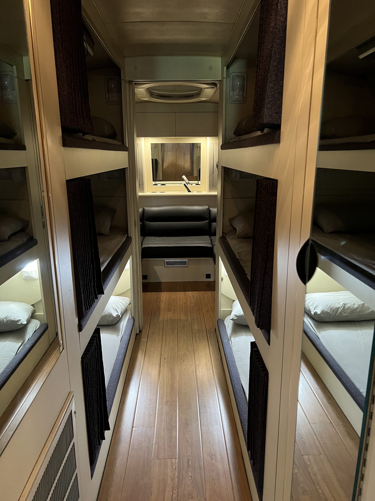 Bunk hallway with flip-down TVs